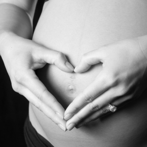 Heart Hands over Pregnant Belly